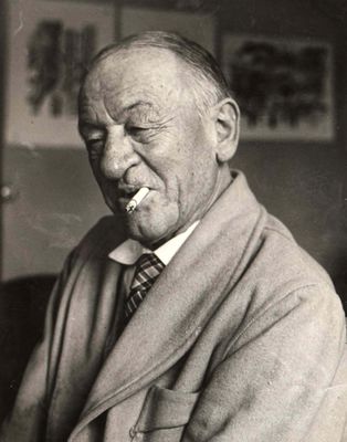 black and white photo of an old man smoking a cigarette