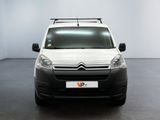 the white van is parked in a large room with a black floor