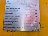 a sign on the side of a yellow machine