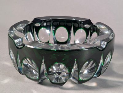 a glass ashtray that is sitting on a table