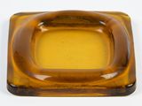 a brown square shaped glass ashtray on a white surface