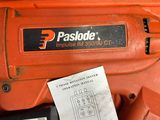 an orange electric driller with a paper attached to it