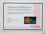 a certificate of authenticity on a card with a picture on it