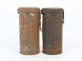 two old metal trash cans sitting next to each other on a white surface