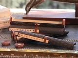 a stack of books sitting on a table next to a statue of a hand