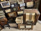 a pile of old radio ' s sitting on the floor