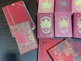 a lot of red books on a table together