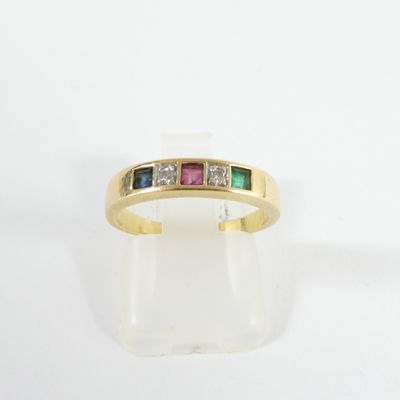 a close up of a gold ring with three different colored stones