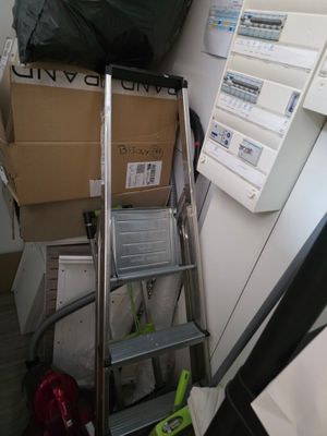 une échelle posée à côté d'une pile de cartons