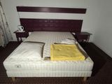 a bed with two pillows and a blanket on top of it