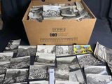 a box full of old black and white photos on a table