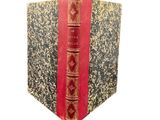 a book with a red cover sitting on a table