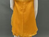 the back of a mannequin wearing a yellow dress on a mannequin mannequin