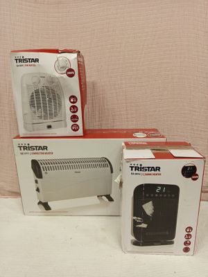 three boxes of a small heater sitting on top of a white table