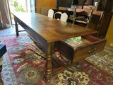 a large wooden table with a drawer underneath it