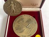 an image of a medal in a box with a coin in it