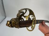a person holding a sword with a dragon on it