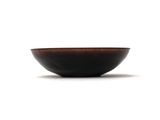 a brown bowl sitting on a white surface with a white background