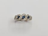an image of a diamond and sapphire ring on a white background
