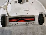 a close up of a vacuum cleaner with a red cloth