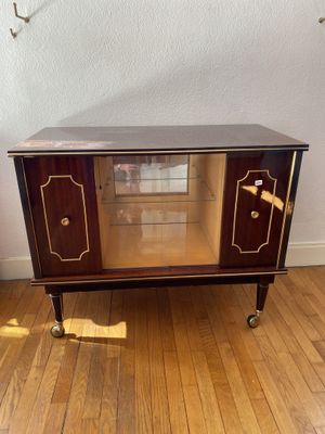 a small cabinet that is sitting on a wooden floor