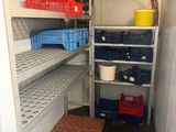 a small room with shelves and bins in it