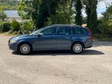 a blue car that is parked in a parking lot