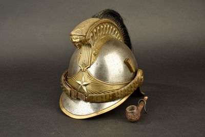 a gold helmet with a bird on top of it