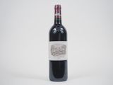 the bottle of red wine is sitting on the table