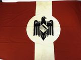 an old flag with an eagle on the front and a cross on the back