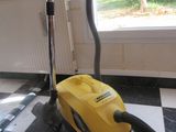 a yellow vacuum sitting on a black and white checkered floor