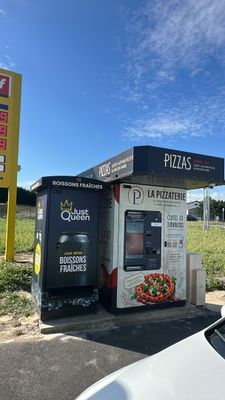 a vending machine in the middle of a parking lot