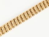 a close up of a gold chain on a white background