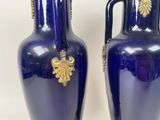 pair of blue vases with gold handles on a white background