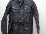 the jacket is hanging on a hanger on the wall
