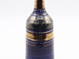 a blue and gold vase on a white background