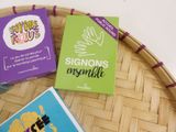 three books that are sitting on top of a basket