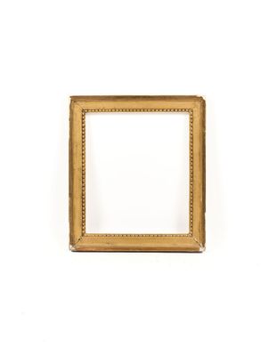 a gold picture frame on a white wall with a white background