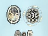 a picture of a brooch and a pin on a blue background