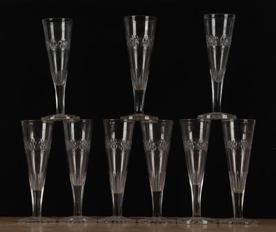 six flûtes à champagne vides alignées sur une table, sur fond noir