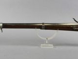 an old rifle with a wooden barrel and a metal handle