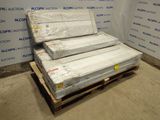 three mattresses stacked on a pallet in a room