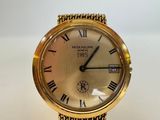 a close up of a gold wrist watch with roman numerals