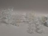 a lot of glasses and vases sitting on a table