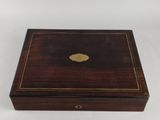 a small wooden box with a gold leaf on the lid