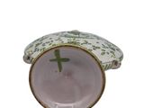 a small white and green bowl with a bird on it