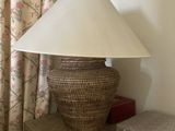a lamp that is sitting on a table next to a pillow