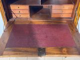 a wooden desk with two drawers and a rug on the floor