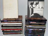 two stacks of cds and a book sitting on top of each other