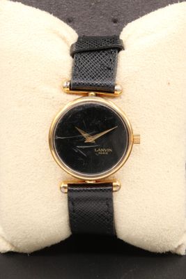 an image of a close up of a wrist watch on a pillow